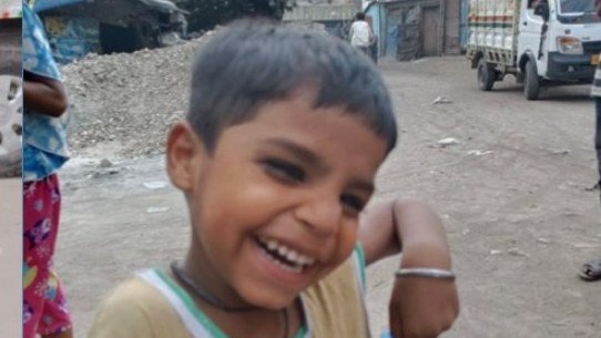 A smiling girl holding new clothes